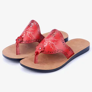 Stylish red women's PU leather flip-flops with floral cutout details and non-slip soles