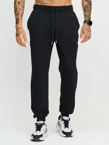 Detail view of men's black cuffed joggers with drawstring for athletic and casual wear