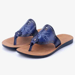 Women's blue PU leather thong sandals with laser-cut floral patterns and tan sole