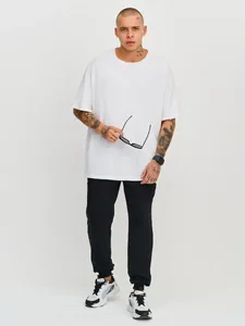 Professional full body view of men's casual black jogger pants and white t-shirt sports outfit.