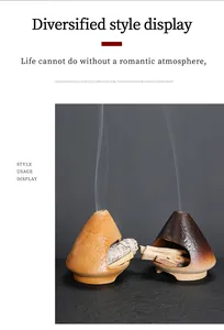 Pair of ceramic Palo Santo burners with sage and wood sticks emitting smoke.