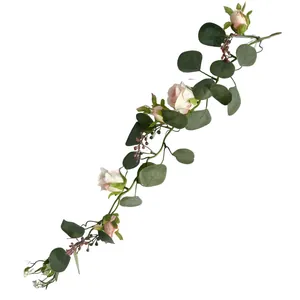 Close-up detail of artificial eucalyptus vine with realistic pink French roses for decor