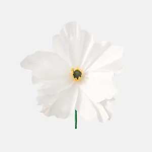 Detailed macro view of a handmade white crepe paper poppy flower with a green stem
