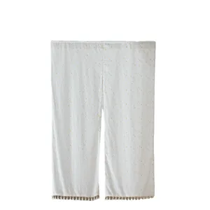 White Japanese Noren door curtain with yellow polka dots and decorative tassel fringe