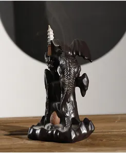 Close-up detail of a mystical ceramic dragon backflow incense burner with smoke effect