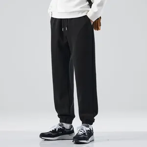 Stylish men's black casual jogger sweatpants with elastic cuffed ankles for sports and fitness