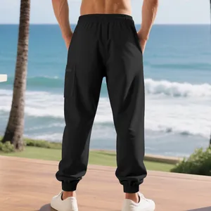 Back view of men's black heavy cargo joggers showing the tapered leg and pocket detail