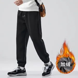 Detailed view of men's black fleece-lined joggers featuring warm inner fabric texture