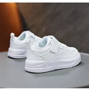 Close-up detail of lightweight white children's casual sneakers with velcro strap