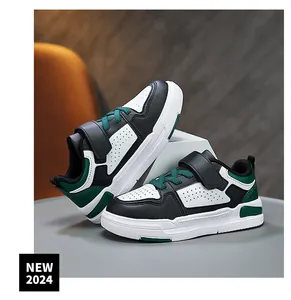 Detailed view of kids' casual leather sneakers in black, white and green accents