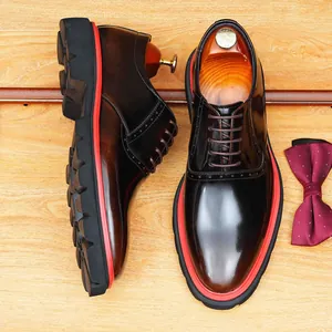 Chaussures habillées en cuir marron brillant avec semelle rouge épaisse et bout pointu.