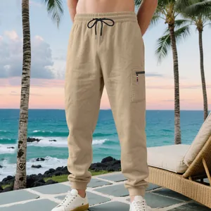Heavyweight khaki men's joggers with cargo pocket and drawstring waist in a beach setting