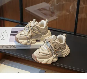 Close-up of stylish beige girls' chunky sneakers with warm plush lining on a book prop