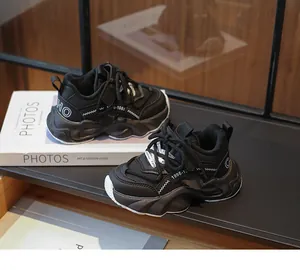 Close-up of black children's chunky sneakers with mesh and fashion prints