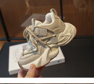 Macro view of beige chunky sneakers for girls featuring warm lining and velcro straps