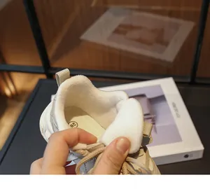 Detailed macro view showing the soft plush lining inside girls' white sports sneakers