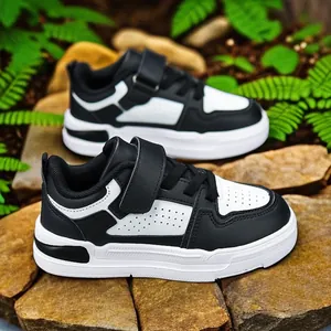 Stylish black and white children's casual leather sneakers with hook and loop closure