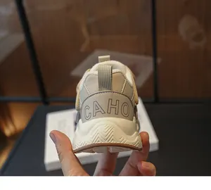 Detailed rear view of children's dad sneakers featuring CAHO logo on the heel.