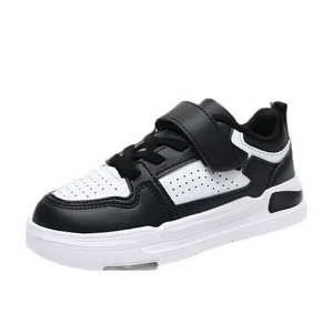 Durable black and white children's leather sneakers with convenient hook-and-loop strap