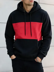 Close-up of black and red color-blocked men's hoodie with a soft fleece texture