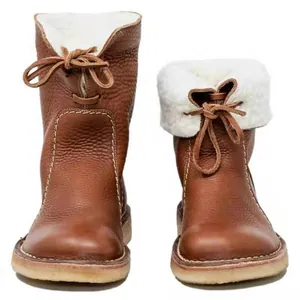 Detailed view of brown leather snow boots featuring cozy white fleece lining and lace-up front