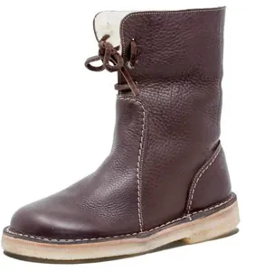 Detailed view of brown pebbled leather snow boots with cozy white fleece lining and laces