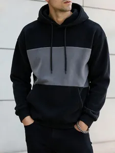 Close-up detail of men's fashion color-block hooded sweatshirt in black and grey colors