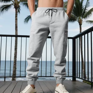 Men's heavyweight grey joggers featuring a functional cargo pocket and drawstring waist