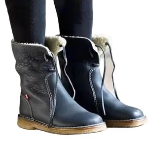 Detail view of women's leather ankle boots with warm faux fur lining and lace-up front.