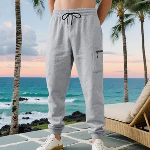 Detail of grey heavyweight men's joggers with zippered cargo pocket and elastic cuffs.
