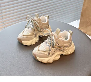 Detailed macro view of beige children's breathable dad sneakers with stylish chunky soles