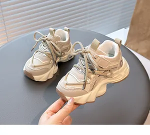 Detail view of stylish beige girls' mesh sneakers with thick wavy soles