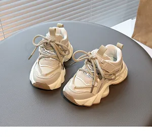 Detailed macro view of girls' beige breathable mesh sneakers with wavy thick soles