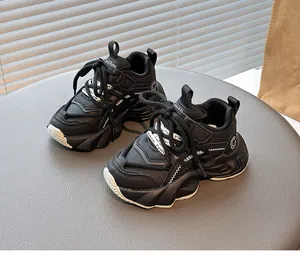 Close-up view of black children's chunky sneakers featuring breathable mesh and G logo