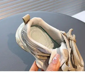 Close-up detail of breathable mesh and cushioned insole in girl's beige sports sneaker.