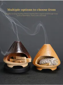 Close-up of ceramic incense burners shaped like mini fireplaces with smoke