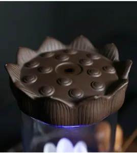 Macro view of detailed brown ceramic lotus seedpod lid for backflow incense burner