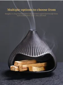 Ceramic volcano incense burner with Palo Santo sticks and elegant rising smoke detail