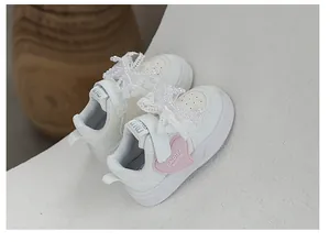 Girls' white sneakers with lace pearl bows and pink heart detail, 2025 spring collection.