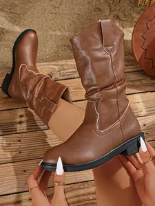Detail of brown Western mid-calf boots for women featuring chunky heel and V-cut top