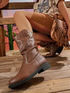 Brown mid-calf western cowboy boots with V-cut top and slouchy chunky heel design