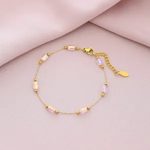 Close-up of gold titanium steel bracelet with six iridescent pink rectangular crystals