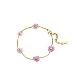 Elegant titanium steel bracelet with purple crystal flowers and gold chain for daily wear.