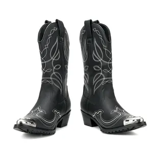 Stylish black western cowboy boots featuring intricate white embroidery and metallic toe caps