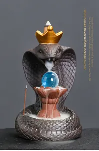 Detailed close-up of a cobra backflow incense burner with smoke flowing over a blue orb