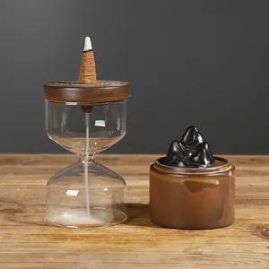 Creative ceramic backflow incense burner with mountain design and glass cover.