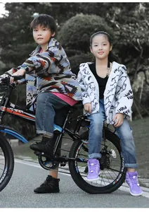 Close-up of children wearing purple and black fleece-lined warm snow boots outdoors