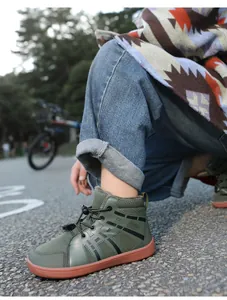 Detail of children's warm green snow boots with thick plush lining and rubber sole