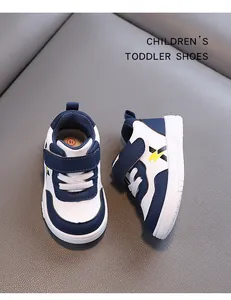 Close-up view of navy blue and white toddler walking shoes with anti-slip soft soles