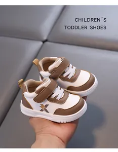 Close-up of brown and white toddler walking shoes with Velcro straps.
